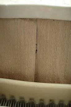 Peeling wallpaper behind a radiator