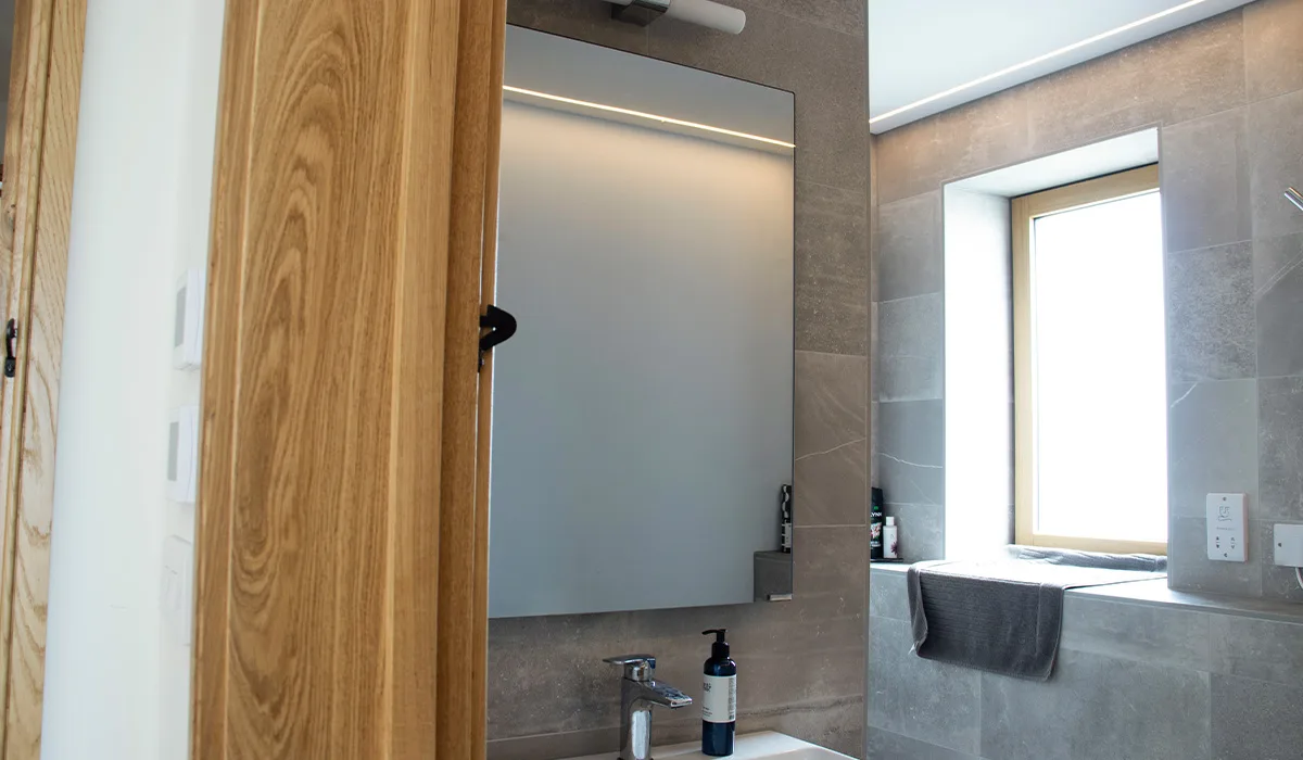 Select XLS mirror panel installed in bathroom