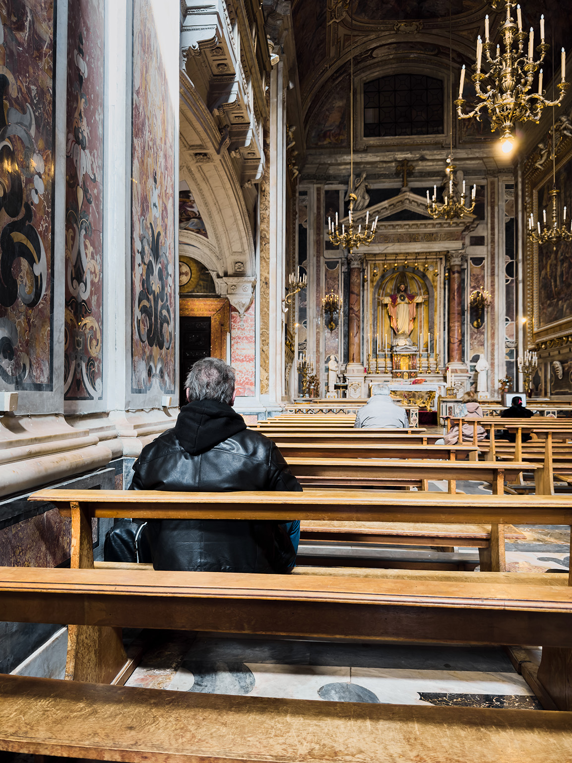 Man in a church sitting on pew